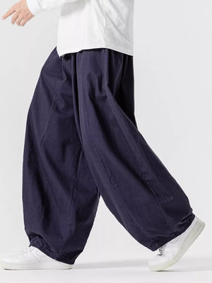 Navy relaxed fit drawstring sweatpants with baggy legs and cuffed ankles.