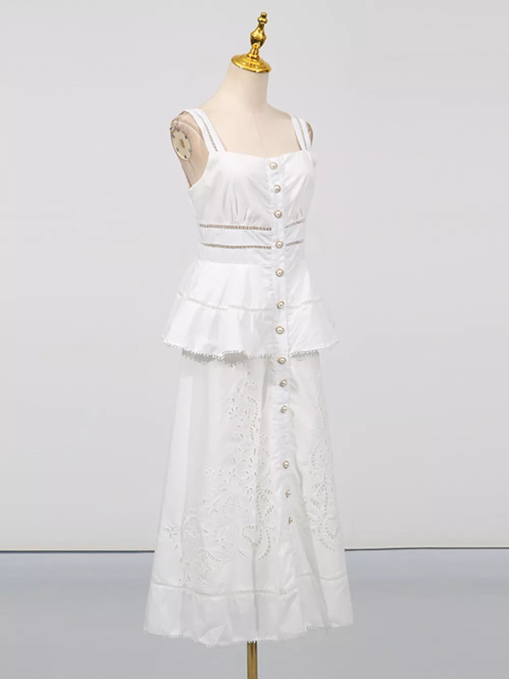 White eyelet embroidered midi dress with button front, tiered ruffle, and cutout waist detail.