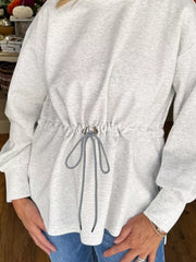 Light gray drawstring waist tunic sweatshirt with a cinched waist and tie detail.