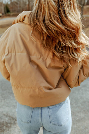 Tan padded crop jacket with stand collar, shown from the back.