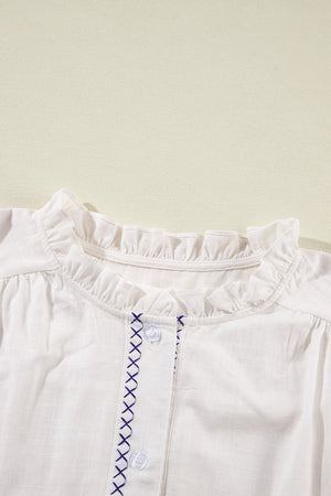 White embroidered blouse with ruffled neckline and button front