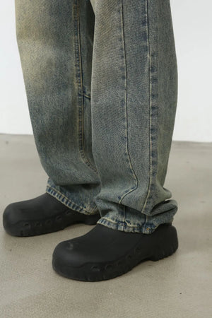 Faded wash baggy carpenter jeans in medium, showing a close-up of the leg and shoe detail.