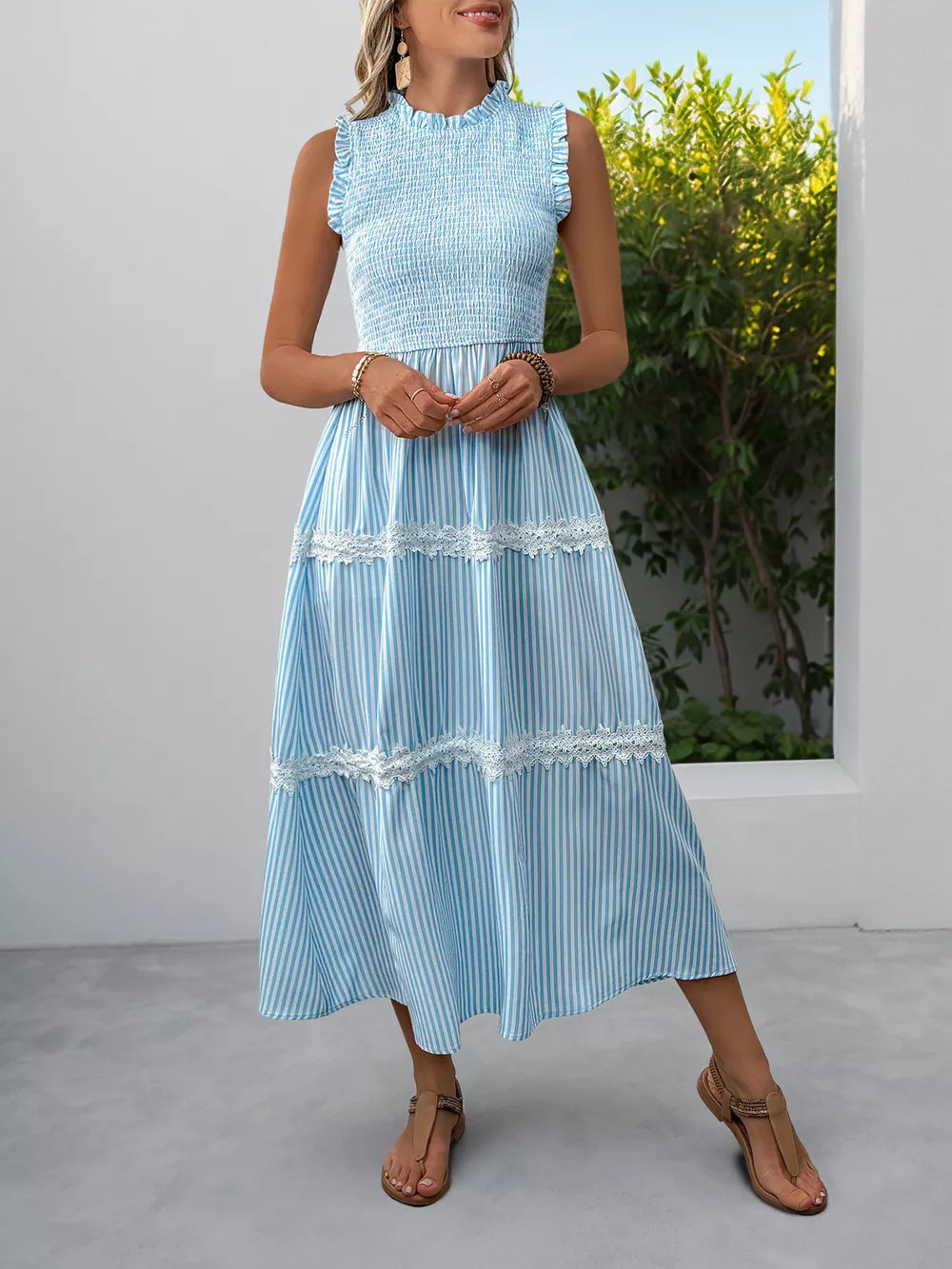 Blue striped midi dress with smocked bodice and lace trim tiers.