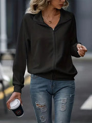 Black ribbed zip-up track jacket with raglan sleeves and stand-up collar.