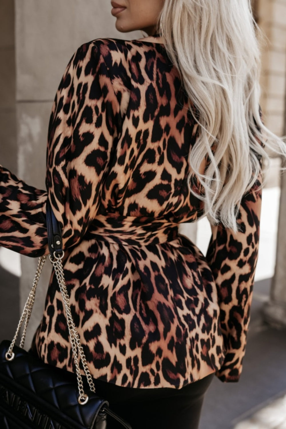 Leopard print wrap blazer with a cinched waist and chain detail purse.