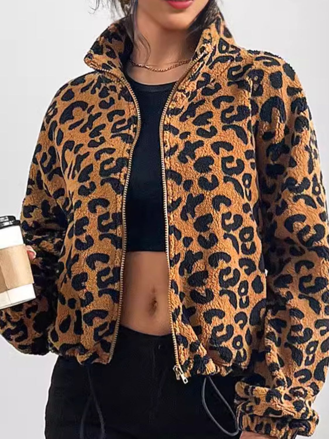 Caramel leopard print sherpa bomber jacket with zip front and drawstring hem.