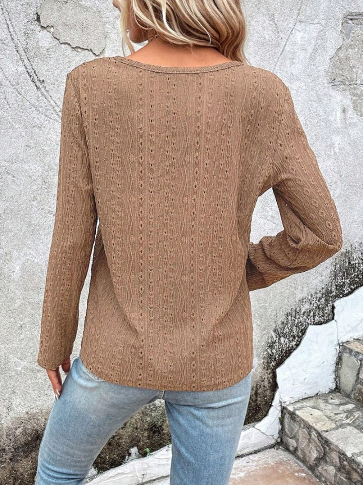 Textured long sleeve henley top in camel with open knit pattern.
