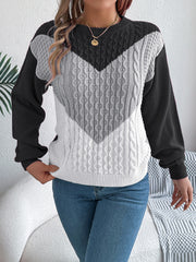 Chevron cable knit sweater with contrast black, gray, and white panels.