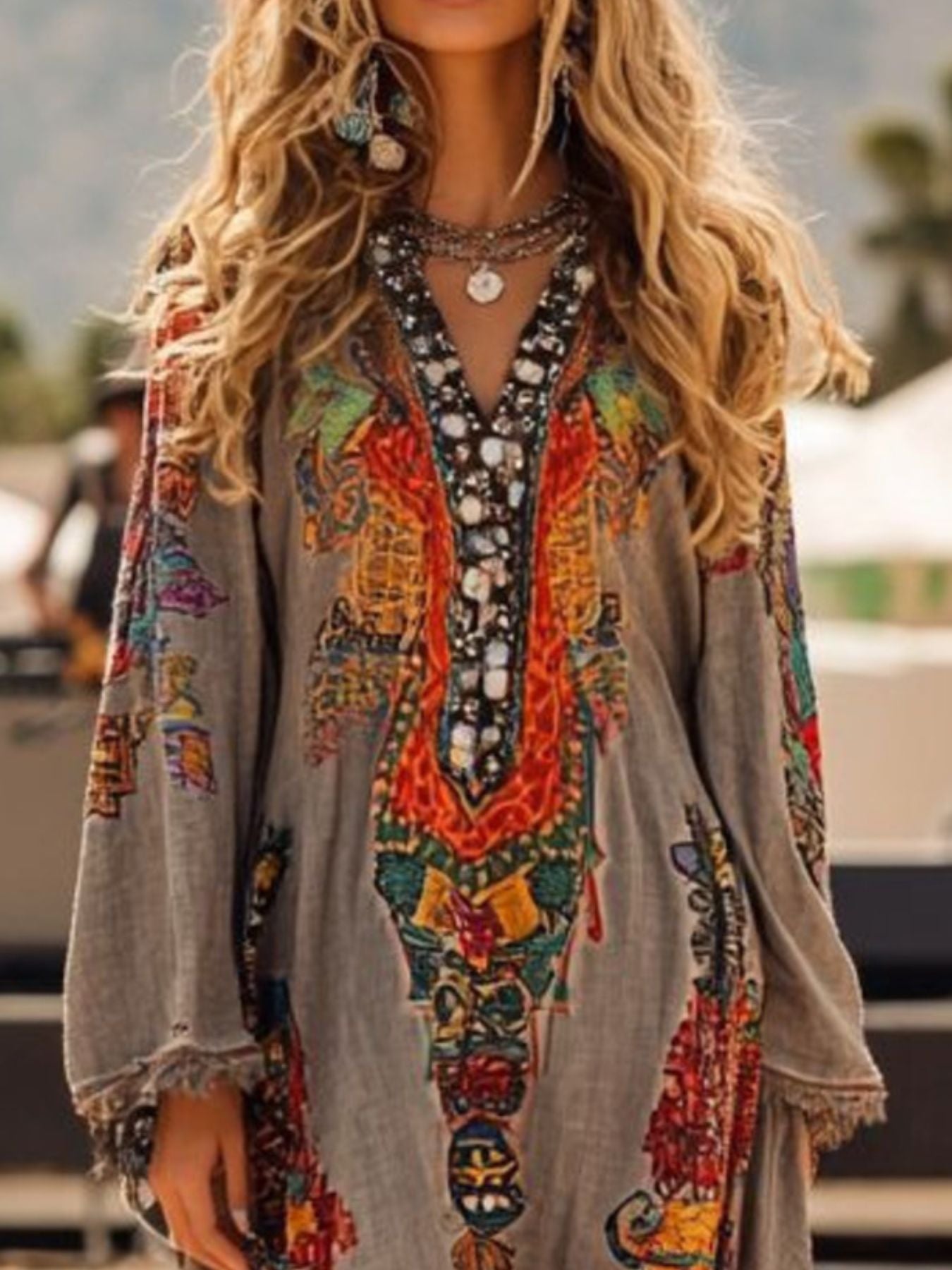 Bohemian gray long-sleeve dress with colorful embroidered neckline and frayed cuffs.