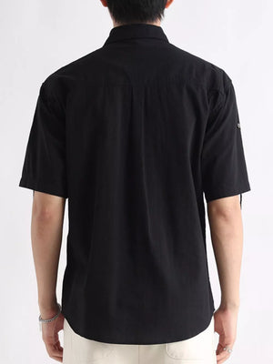 Black relaxed-fit cotton button-down overshirt with short sleeves and a classic collar.
