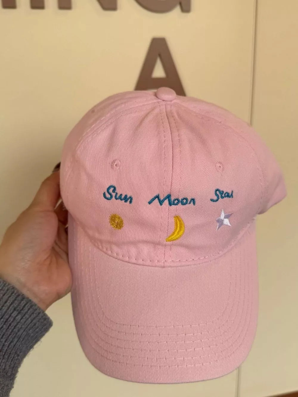 Blush Pink cotton baseball cap with celestial embroidery of sun, moon, and star.