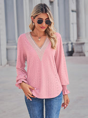 Blush pink eyelet blouse with lace trim V-neck and ruffled cuffs.