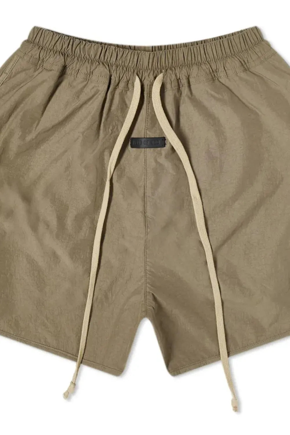 Taupe nylon drawstring shorts with curved hem and black logo tag.