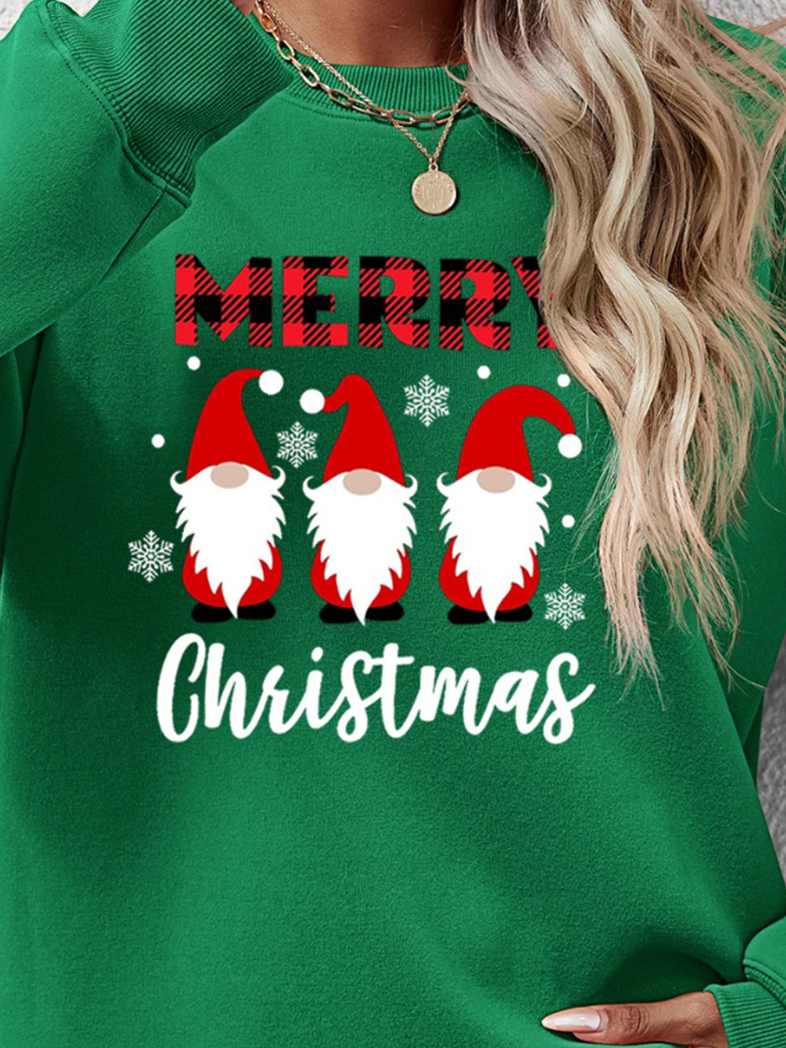 Green Christmas gnome graphic sweatshirt with Merry Christmas text and snowflakes.