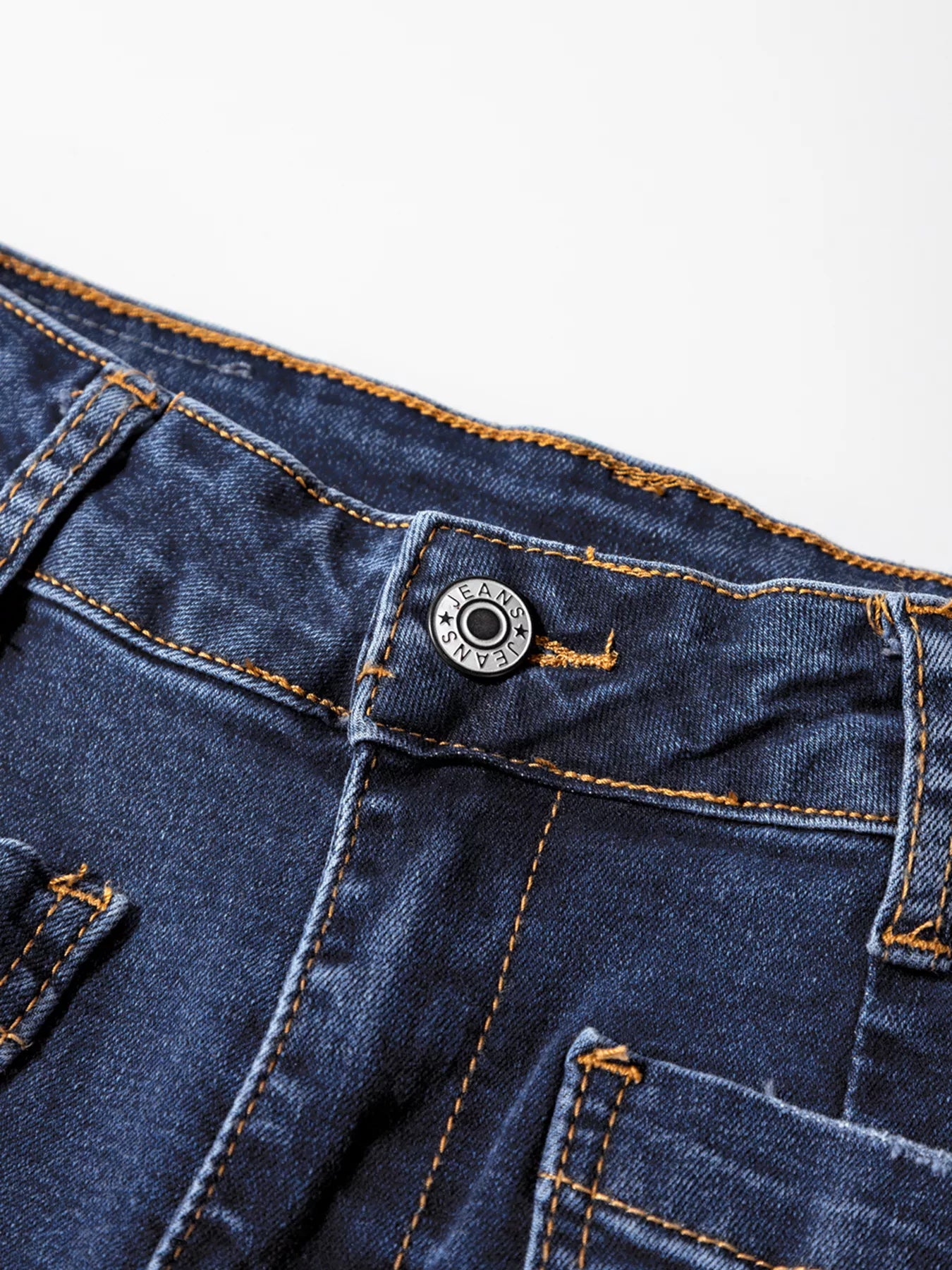 Patch pocket wide-leg jeans in medium wash denim with orange stitching and a branded button closure.