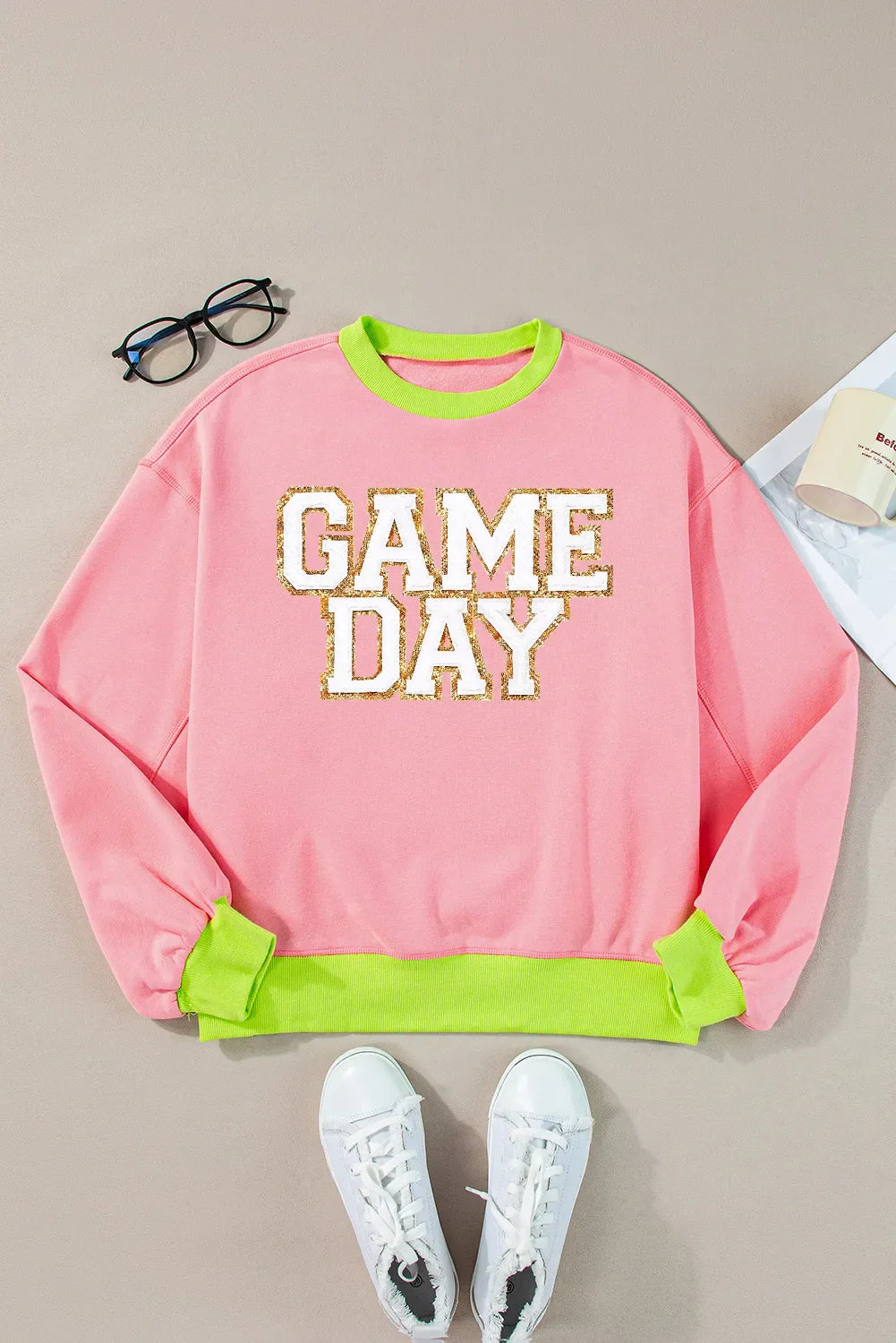 Blush pink sweatshirt with neon trim and glitter appliqué text "GAME DAY