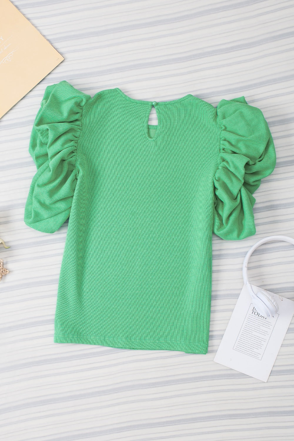Light green short sleeve top with gathered puff sleeves and a keyhole back detail.