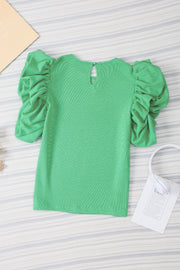 Light green short sleeve top with gathered puff sleeves and a keyhole back detail.