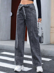 Belted wide-leg washed denim trousers in dark gray with a tie waist and front seams.