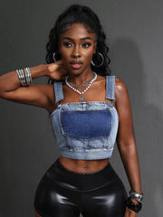 Denim crop top with adjustable straps and buckle details.