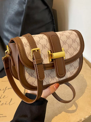 Chic monogrammed flap crossbody bag in beige and brown with gold hardware.