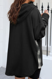 Black waffle knit shacket with plaid trim detail on the side, hooded.