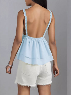 Light blue layered camisole with lace trim straps and a ruffled hem.