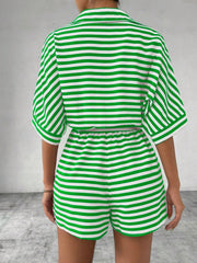 Green and white striped romper with short sleeves and elastic waist shorts.