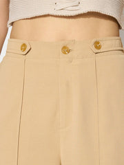 Tan wide leg trousers with button detail and front seams.