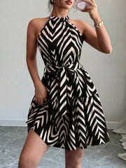 Black chevron print halter neck tie-waist ruffle dress with tiered skirt.