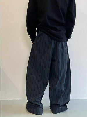 Men's dark grey striped wide-leg sweatpants with pockets.