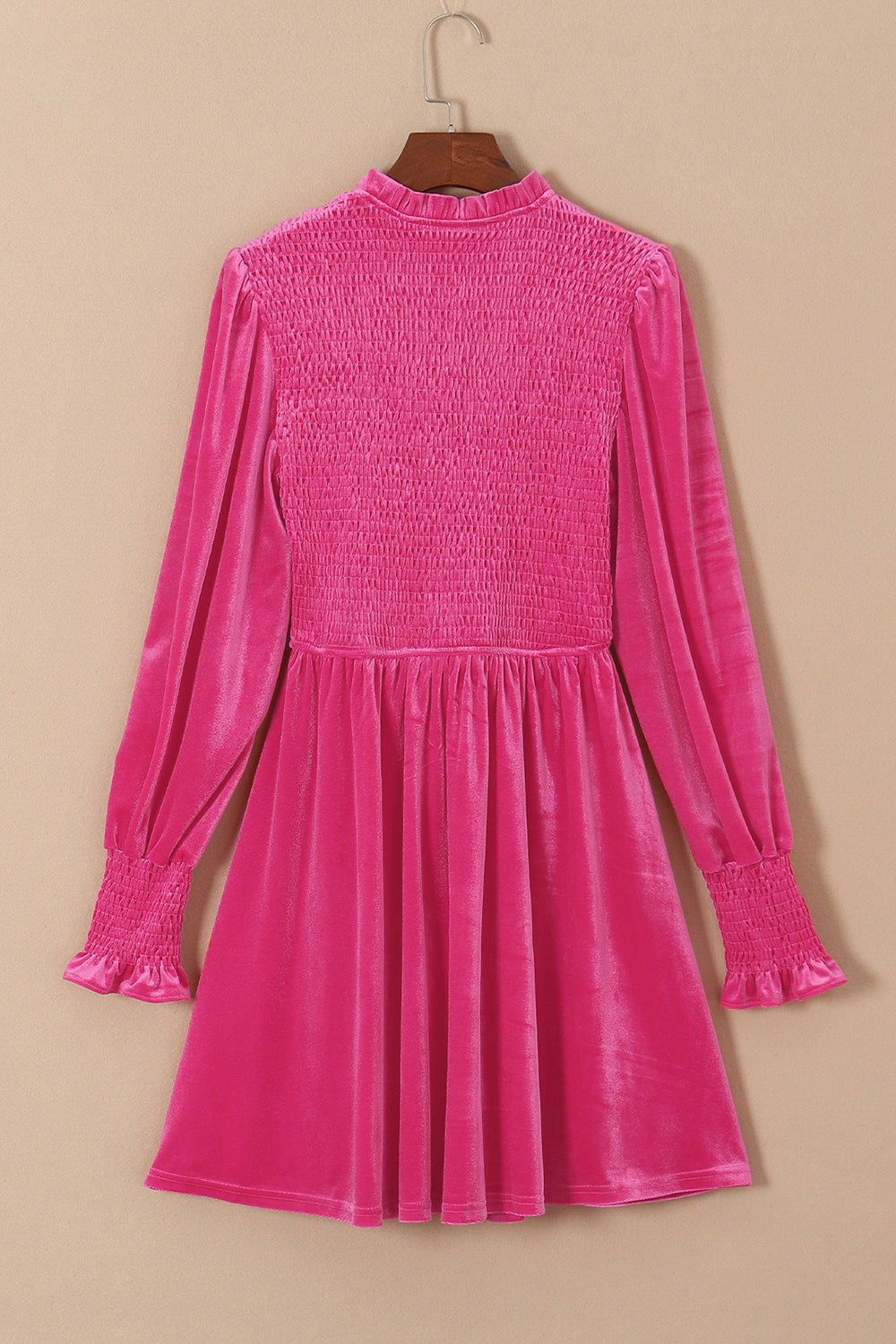 Hot pink velvet mini dress with smocked bodice and long puff sleeves.