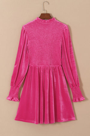 Hot pink velvet mini dress with smocked bodice and long puff sleeves.