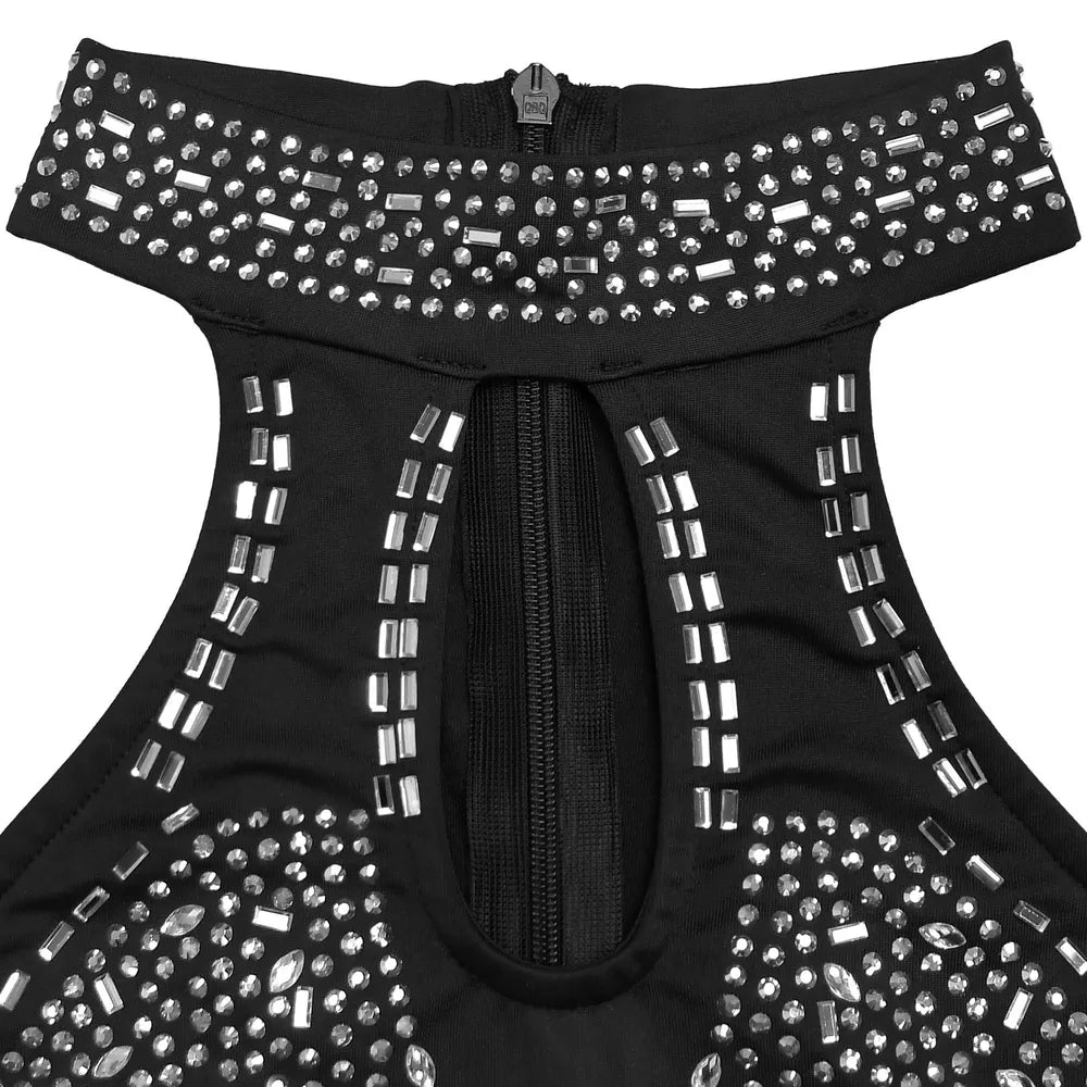 Black halter neck romper with rhinestone embellishments and front zipper detail.