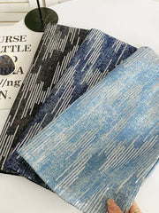 Shimmering sequin mini skirt fabric in light blue, dark blue, and black with diagonal sequin pattern.