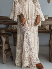 Cream lace maxi dress with deep V-neck, bell sleeves, and tiered skirt.
