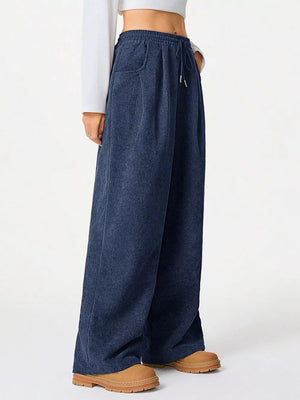 Navy blue corduroy wide-leg maternity trousers with drawstring waist and pockets.