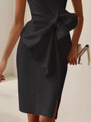 Black sleeveless dress with a large bow detail and side slit