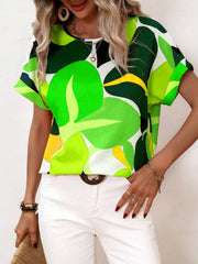 Women's abstract floral print tee in green, yellow, and white with short sleeves and a round neckline.