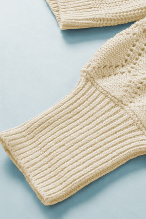 Cream diamond-cut sleeve knit cardigan with ribbed cuffs and textured stitch detail.