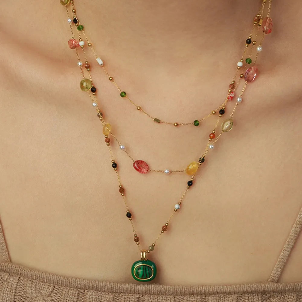 Gemstone Cascade Layered Necklace with green pendant and colorful beads on gold chains