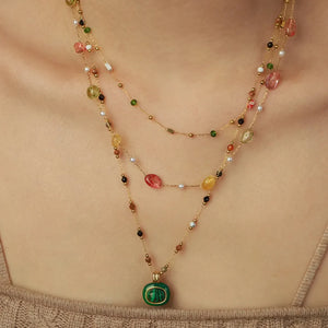 Gemstone Cascade Layered Necklace with green pendant and colorful beads on gold chains