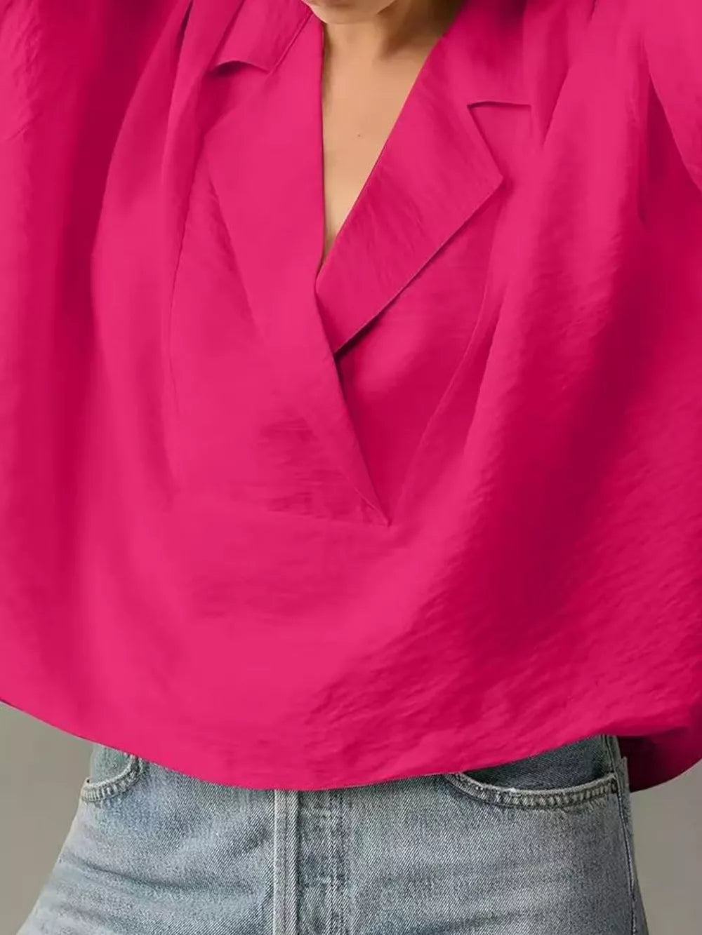 Hot pink V-neck half sleeve shirt with a relaxed fit, styled with denim.