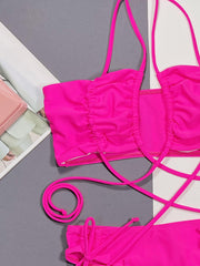 Hot pink ruched strappy bikini set with tie details and crisscross back straps.