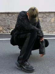 Black velour wide-leg sweatpants with a grey stripe detail on the side.