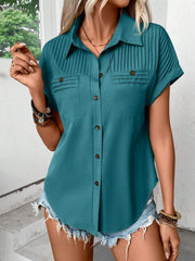 Teal polyester button-down shirt with pleated yoke, two chest pockets, and short sleeves.