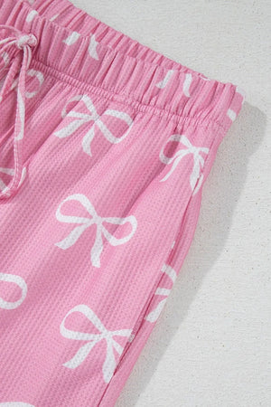 Pink ribbed lounge set shorts with white bow print and drawstring waist