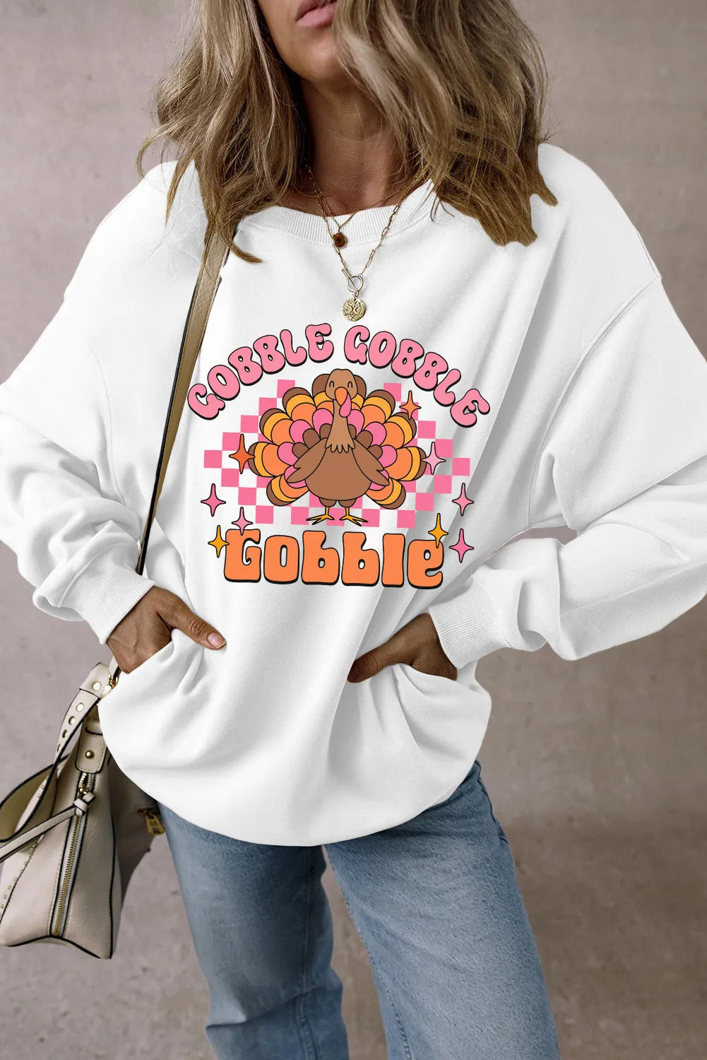 White graphic sweatshirt with retro turkey and "Gobble Gobble" text, crew neck, long sleeves.