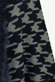 Houndstooth faux fur collar poncho in black with a fuzzy trim detail.