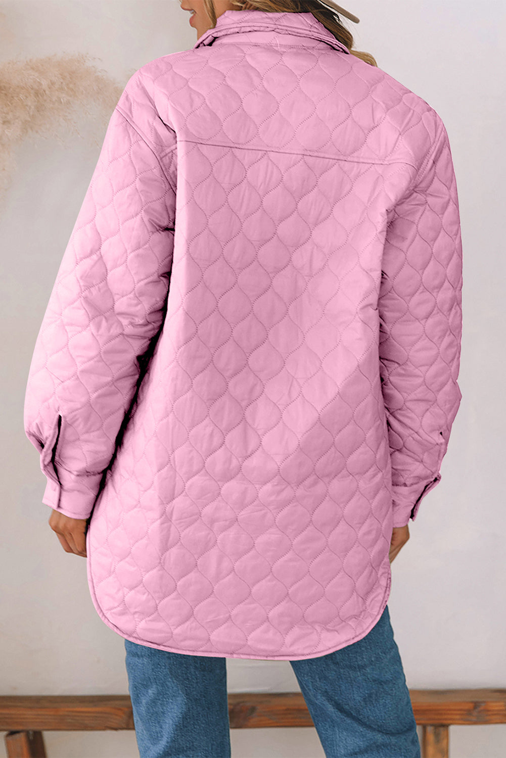Pink quilted utility jacket with a diamond pattern and button cuffs.